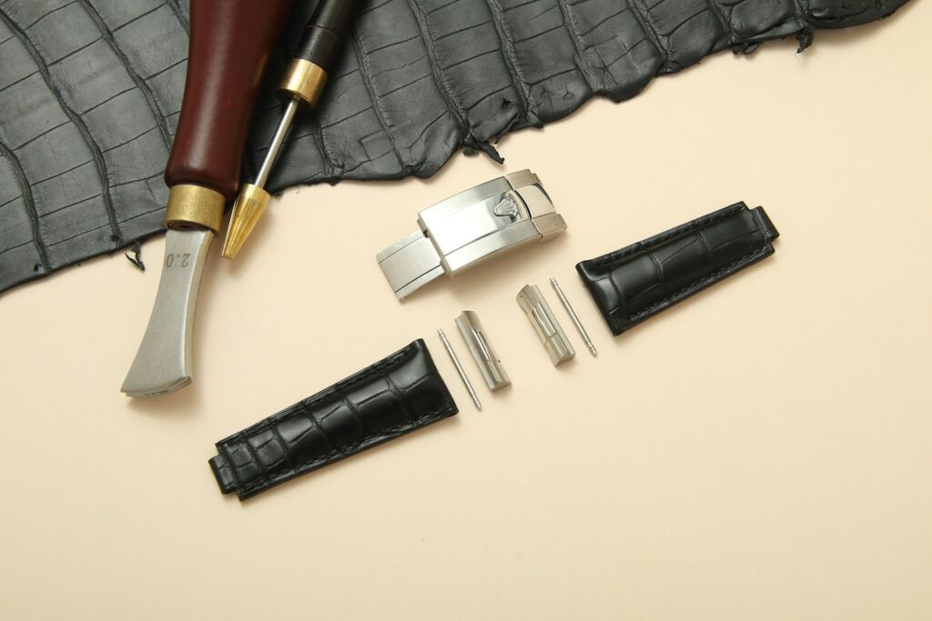 a pen, knife, and other accessories laid out on a table