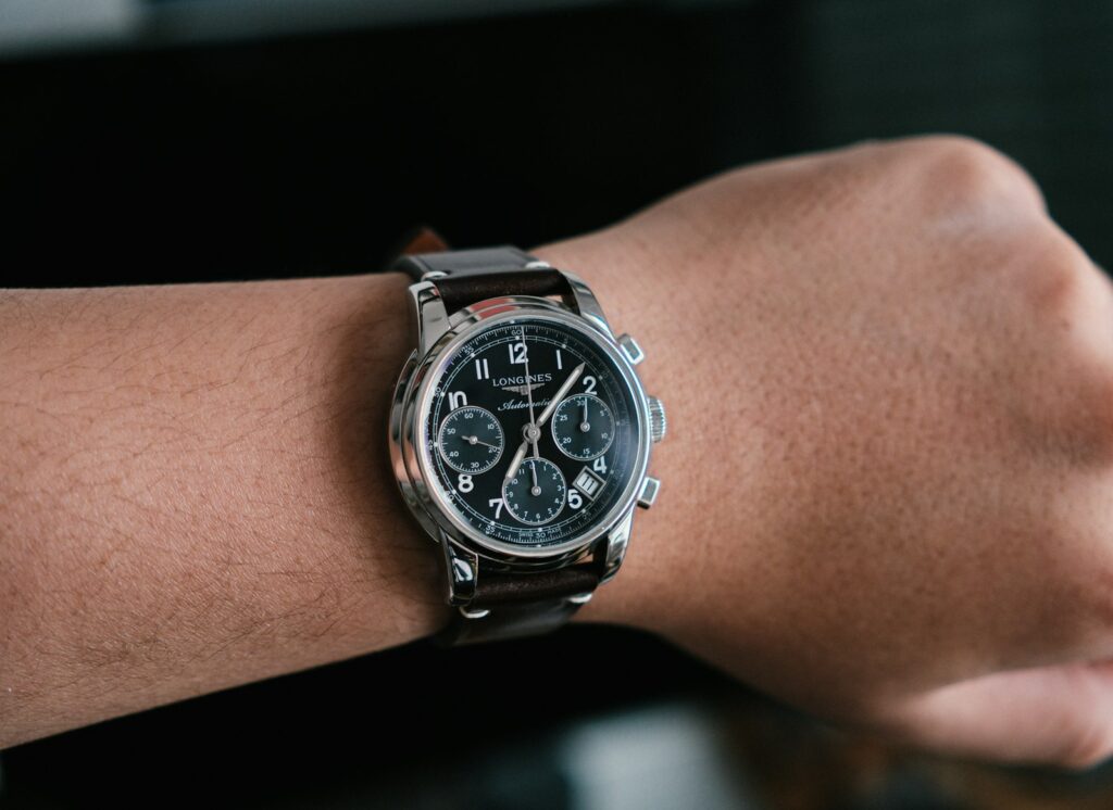 Close-up of a man's wrist wearing a chronograph watch